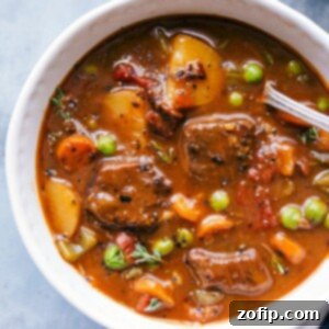Instant pot beef stew in a bowl, warm and hearty, ready to be eaten.