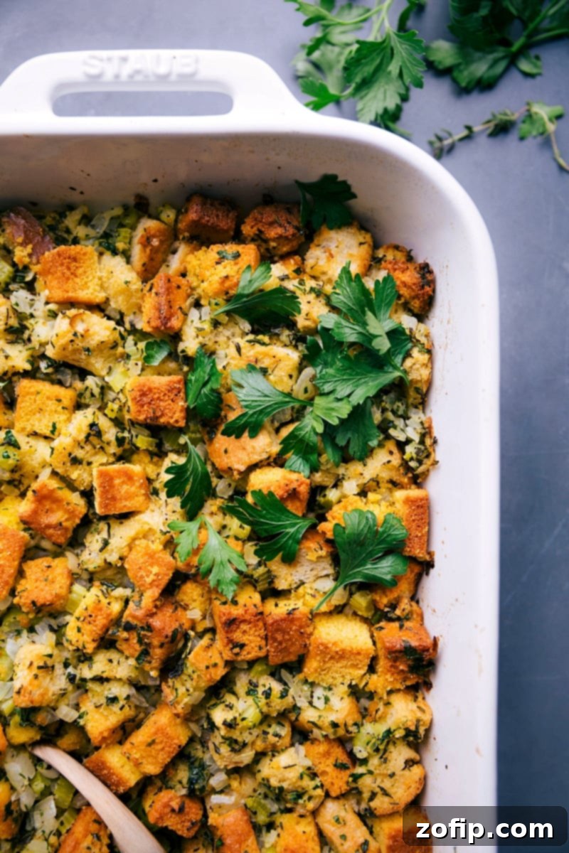 Hearty Comfort Food - Freshly Baked Cornbread Dressing The finished, golden-brown cornbread dressing, glistening with butter and herbs, removed from the oven and ready to be served, a true comforting delight.
