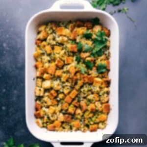 Southern Cornbread Bake 2 Delicious Cornbread dressing fresh out of the oven, garnished with fresh herbs, ready to be served.