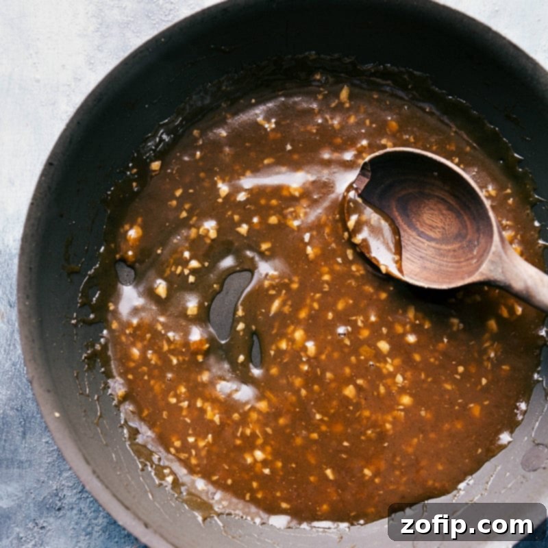 Preparing a sweet and fruity apricot glaze sauce in a pan, showcasing the rich color and smooth texture.