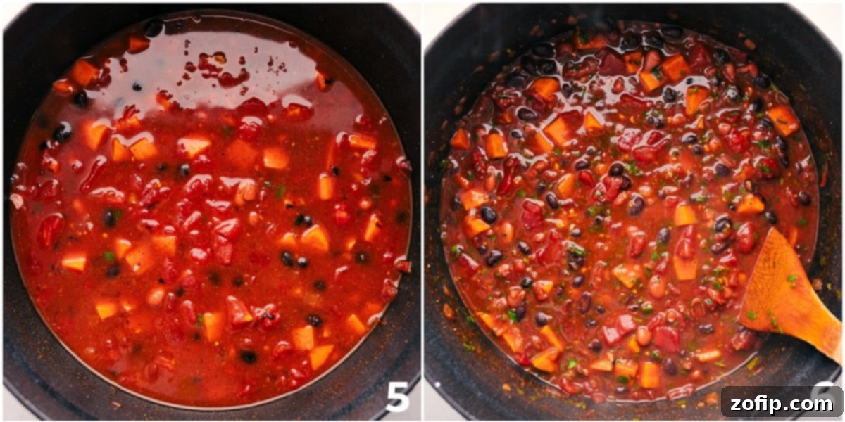 The sweet potato chili simmers gently in a large pot, developing a rich, thick consistency as the flavors meld together.
