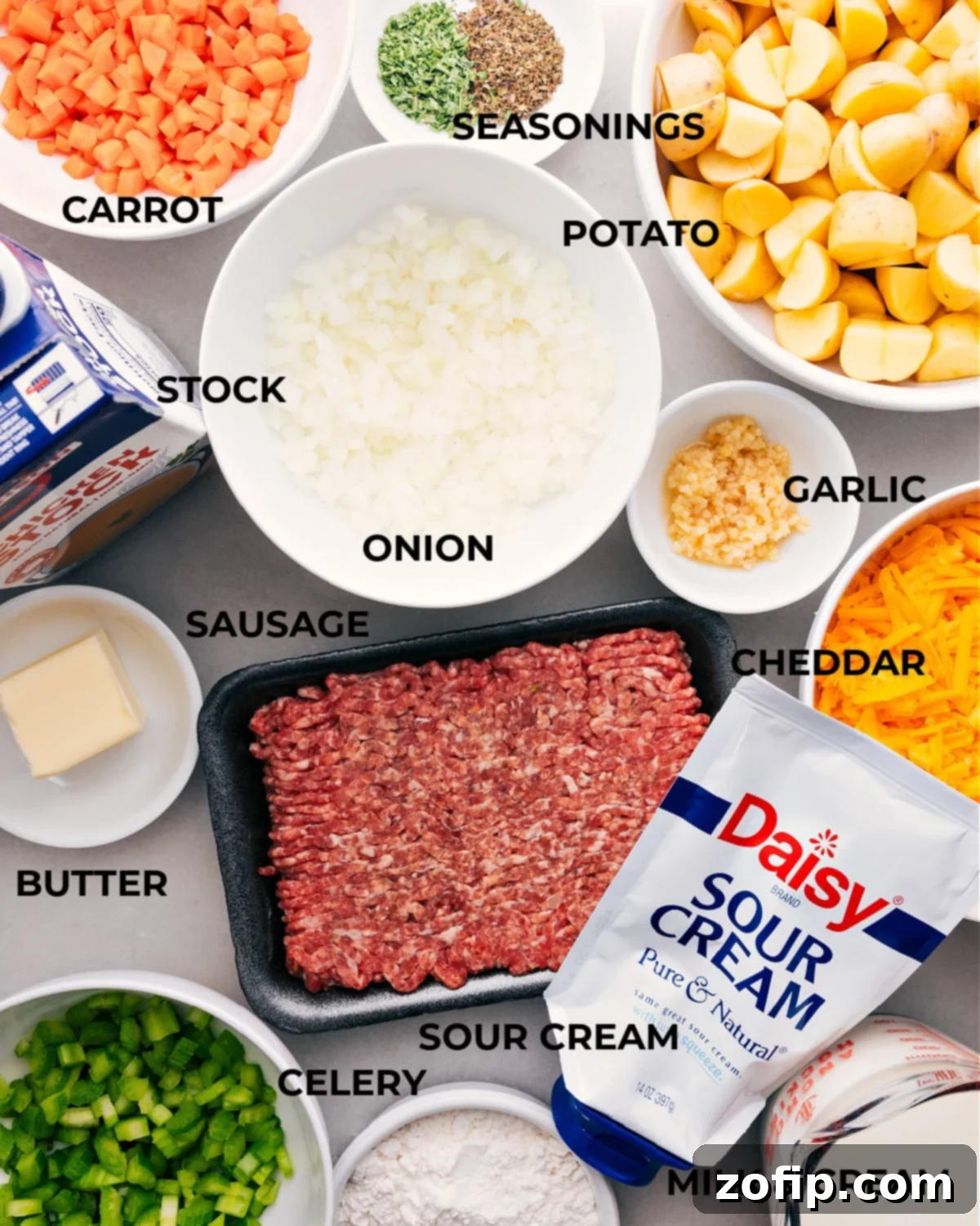 All the vibrant, fresh ingredients for the homemade creamy Sausage Potato Soup are prepped and arranged, including tender potatoes, savory Italian sausage, aromatic vegetables, seasonings, and dairy products, ready for assembly.