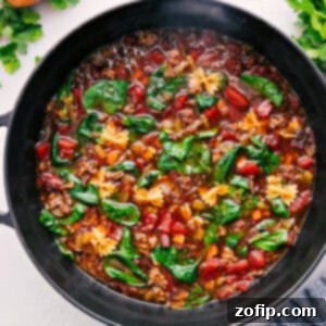 A vibrant bowl of freshly made Pasta Soup with Italian sausage, spinach, and mini farfalle pasta.