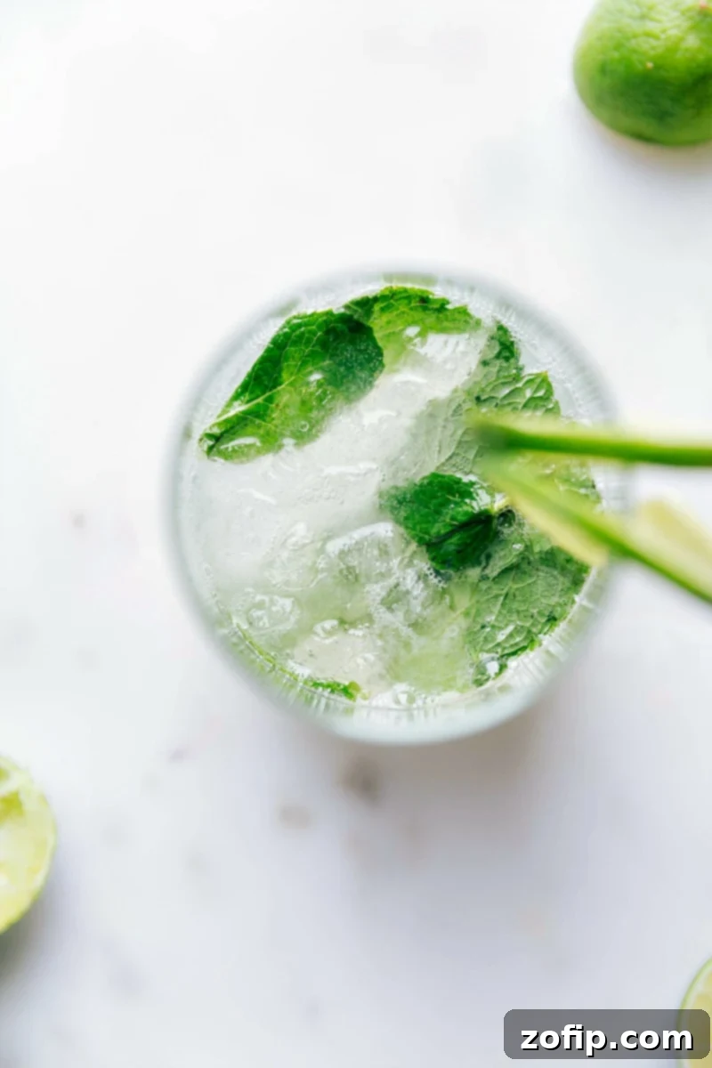 Refreshing Virgin Mojito with Fresh Mint and Lime A beautifully garnished virgin mojito in a tall glass, adorned with fresh mint sprigs and lime slices, ready to be enjoyed.