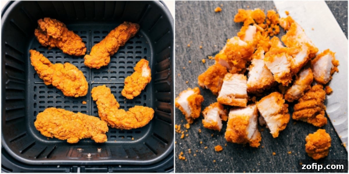 Air Frying for Crispy Chicken Crispy chicken strips cooking to perfection in an air fryer for the Crispy Chicken Salad.