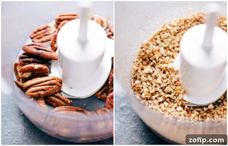 Pecans being finely chopped in a food processor, essential for the recipe's texture and flavor.