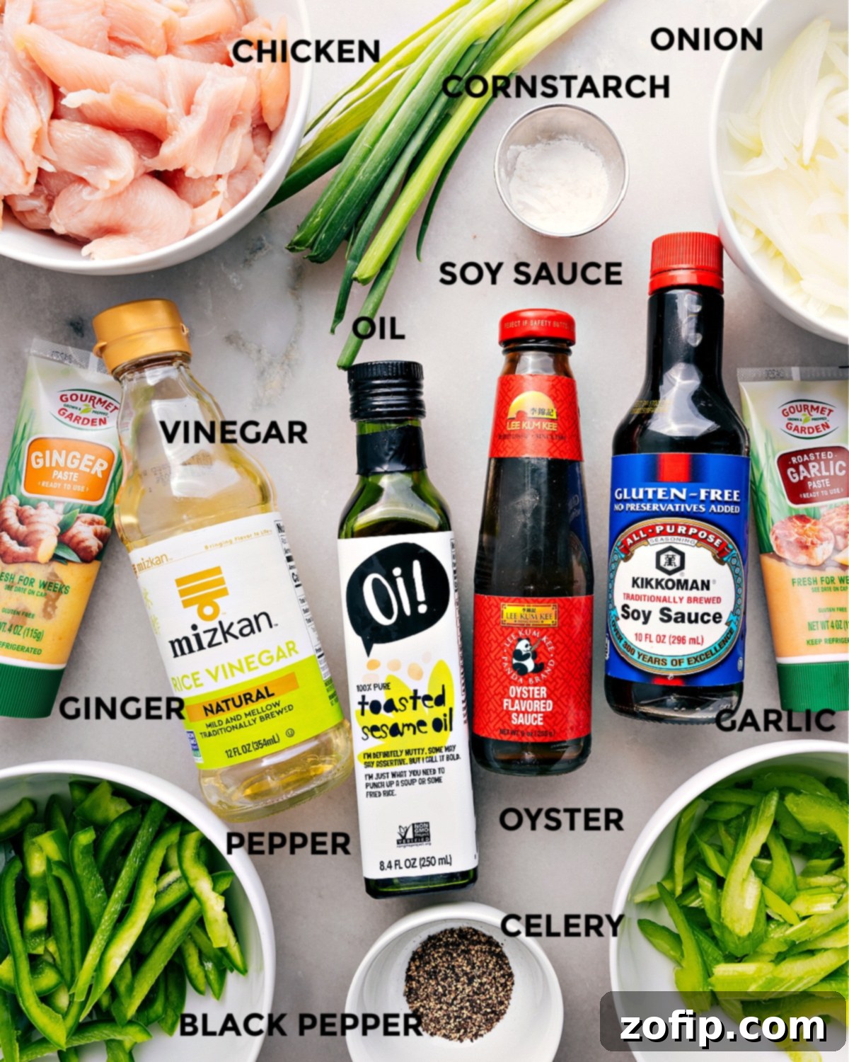 All the essential ingredients for Black Pepper Chicken, neatly prepped and laid out, including sliced chicken, cornstarch, various sauces, fresh ginger, garlic, bell pepper, celery, onion, and black pepper.