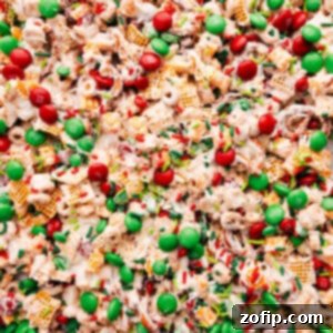 A festive bowl of Christmas Snack Mix with white chocolate, M&M's, and sprinkles.