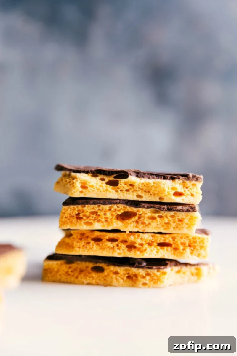 Stacks of shiny, golden Honeycomb Candy pieces on a decorative plate, ready for serving.
