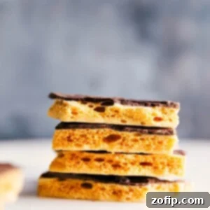 Finished Honeycomb Candy pieces, some dipped in chocolate, on a plate.