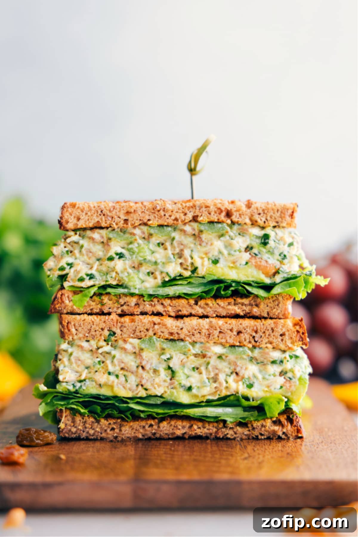 Curry Chicken Salad in whole grain bread stacked on top of each other, showcasing a delicious and healthy meal option.