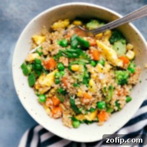 Bowl of quinoa fried rice with colorful vegetables, ready to serve.