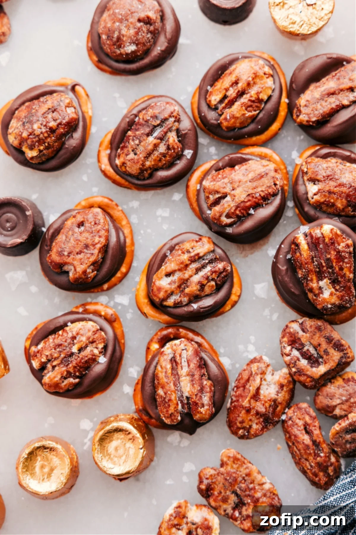 A delicious plate of Rolo Pretzel Turtles, showcasing the golden pretzels, melted caramel-chocolate Rolos, and crunchy pecan halves, sprinkled with flaky sea salt.