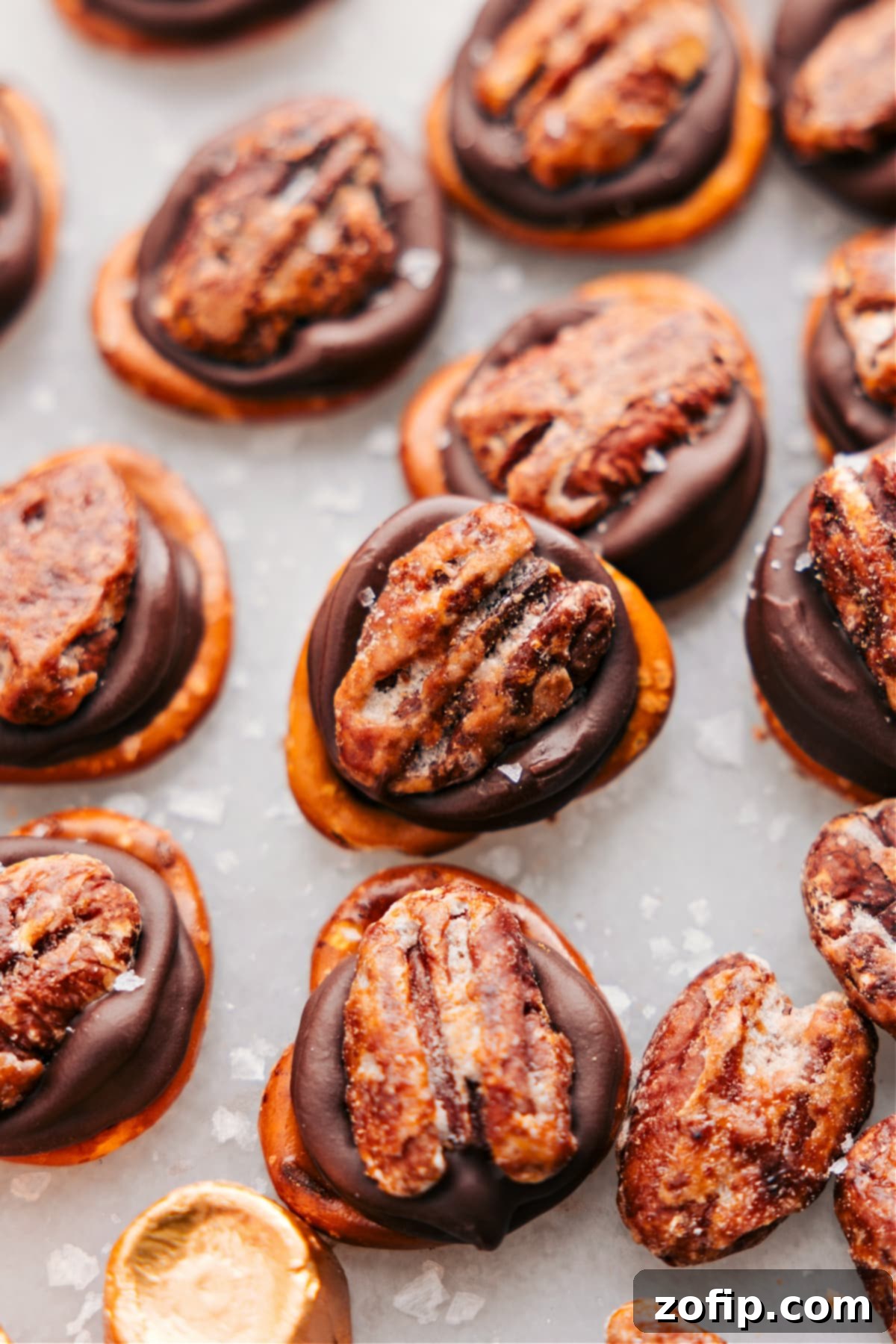 Close-up of freshly made Rolo Pretzel Turtles with a delicate sprinkle of flaky sea salt on top, arranged for a festive holiday presentation.