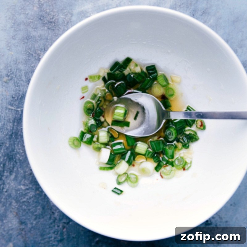 Small bowl filled with a savory green onion vinaigrette, perfect for vegetarian lettuce wraps.