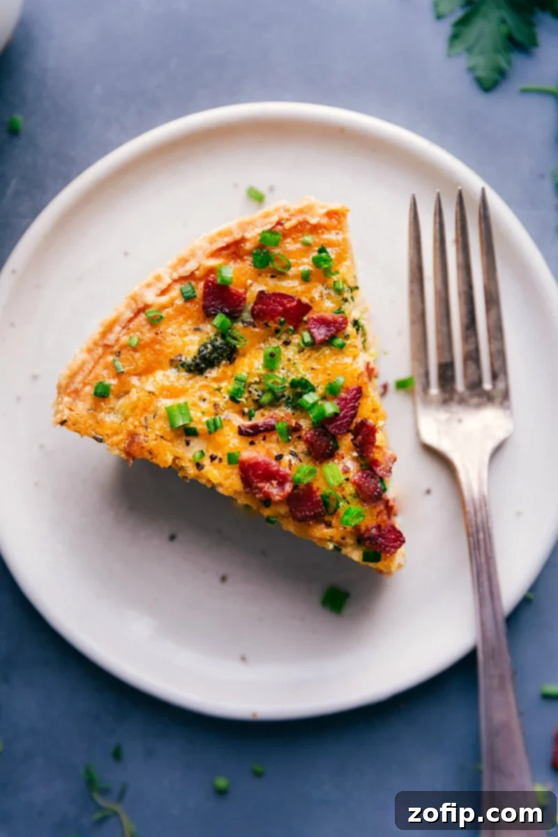 Overhead image of a slice of Broccoli Cheddar Quiche, revealing its tender broccoli, melted cheddar, and creamy filling, with a golden-brown crust.
