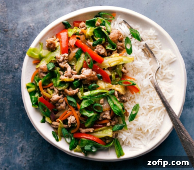 A hearty serving of Egg Roll in a Bowl filling, piled high over a bed of fluffy white rice, presented beautifully and ready for a satisfying meal.