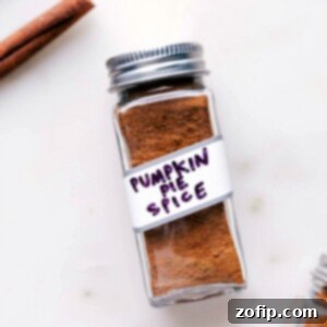 Container of aromatic pumpkin pie spice, a perfect addition to fall recipes.
