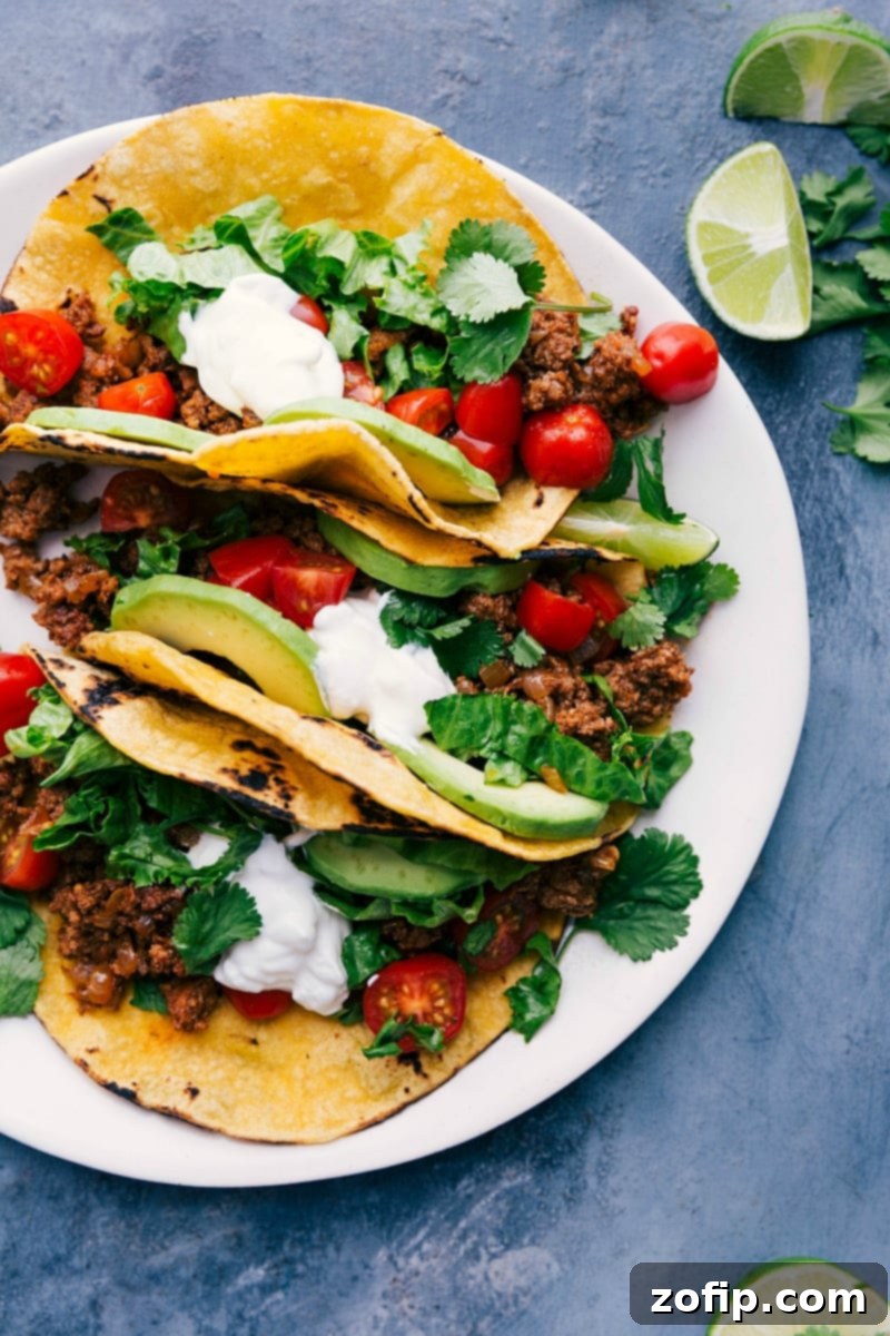 Delicious Turkey Tacos with Toppings and Fresh Lime Wedges, Ready for Enjoyment Tantalizing turkey tacos on a plate, adorned with toppings and accompanied by fresh lime wedges, eagerly awaiting to be savored.