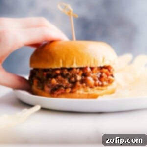 Turkey sloppy joes on a plate, held by a hand, ready to be savored.