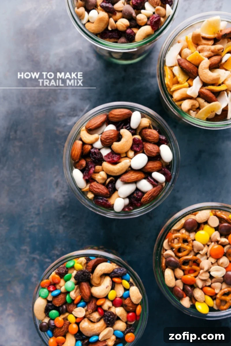Assortment of five different types of delicious trail mix in clear glass jars, showcasing their unique ingredients.