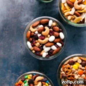 A vibrant mix of homemade trail mix, showing nuts, dried fruits, and various sweet components.