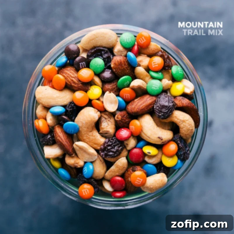 A glass jar filled with finished mountain trail mix snack, showcasing an array of complementing flavors from various ingredients.