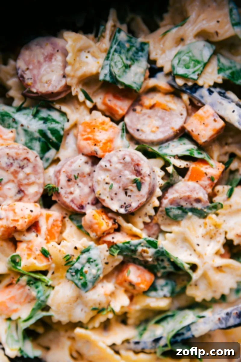 Overhead image of Sweet Potato Pasta with roasted sweet potatoes, chicken sausage, and creamy goat cheese sauce