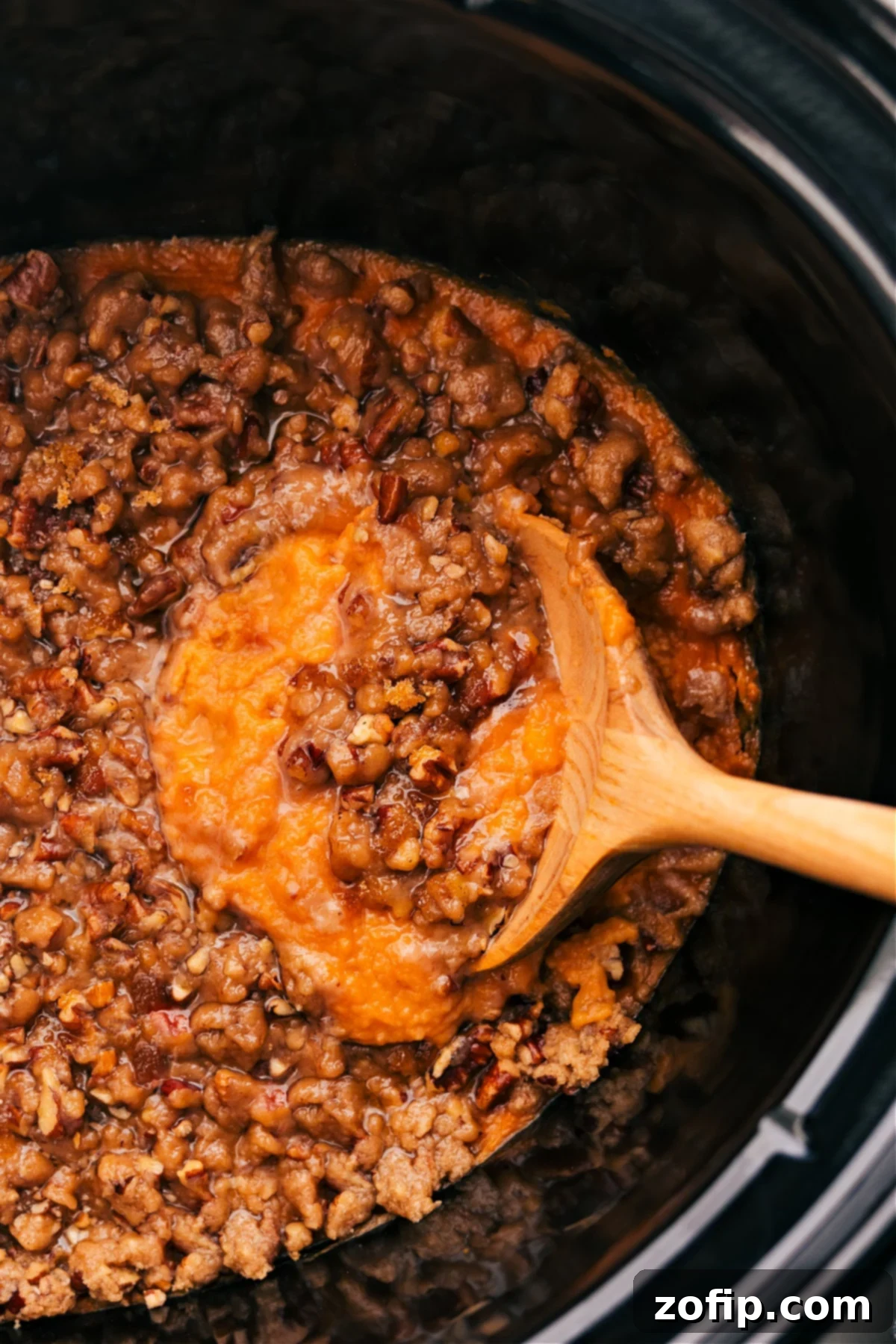 Crockpot Sweet Potato Casserole is ready to serve straight from the slow cooker, garnished beautifully.