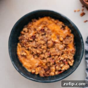 A delicious Crockpot Sweet Potato Casserole with a pecan topping.