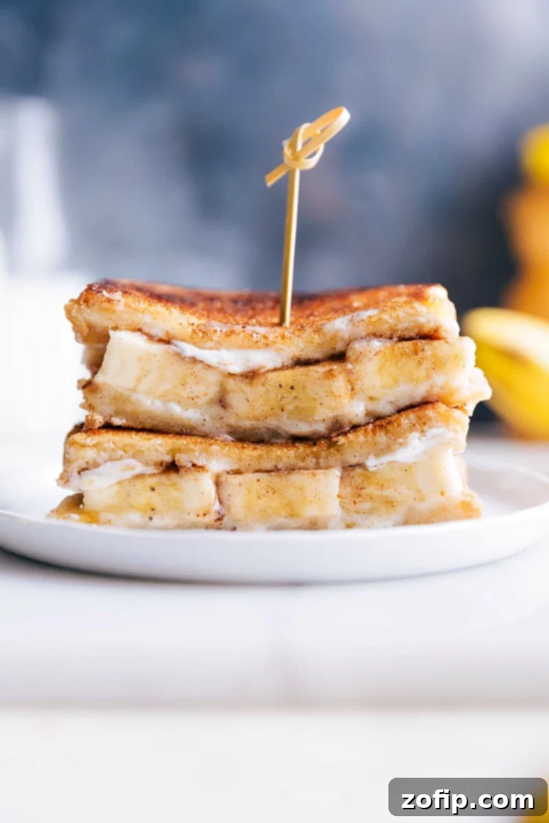 This Honey and Banana Grilled Cheese Sandwich is the BEST -- honestly good enough to pass as a dessert! It all starts with rich buttered brioche bread that is covered in a creamy mascarpone cheese with thick banana slices, a drizzle of honey, and a sprinkle of cinnamon. The bread and bananas get caramelized as they're grilled, which results in an explosion of flavor and the perfect sweetness. Recipe via chelseasmessyapron #healthy #whole #breakfast #snack #best #quick #easy #bread #honey #banana #sandwich Stacked grilled honey and banana sandwiches with a golden, caramelized crust.