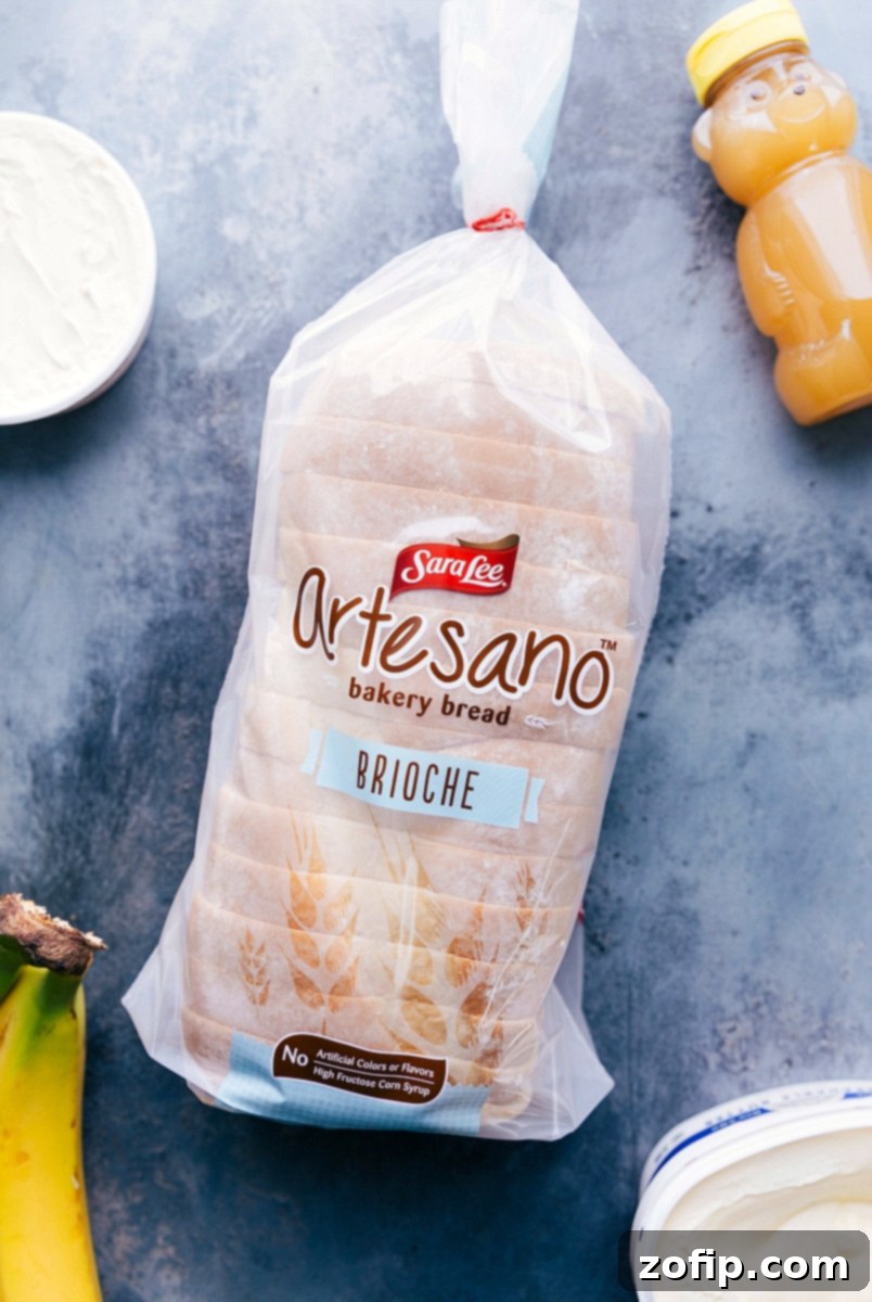 This Honey and Banana Grilled Cheese Sandwich is the BEST -- honestly good enough to pass as a dessert! It all starts with rich buttered brioche bread that is covered in creamy mascarpone cheese with thick banana slices, a drizzle of honey, and a sprinkle of cinnamon. The bread and bananas get caramelized as they're grilled, which results in an explosion of flavor and the perfect sweetness. Recipe via chelseasmessyapron #healthy #whole #breakfast #snack #best #quick #easy #bread #honey #banana #sandwich Overhead image of thick, golden brioche bread slices, perfect for a gourmet sandwich.