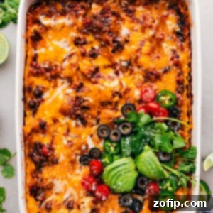 Taco Lasagna in the pan fresh out of the oven, with a crispy cheese topping and visible layers.