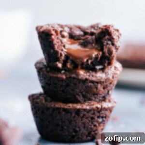 Stack of delectable brownie bites with luscious melted chocolate oozing from the center.