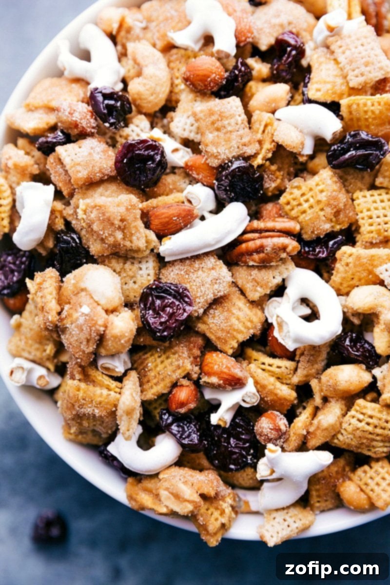 Delicious Dried Tart Cherry Snack Mix in a bowl, featuring a blend of cereals, nuts, and vibrant red cherries, ready for snacking.