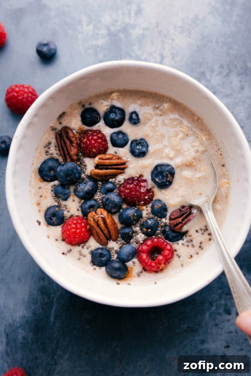 Hearty Oatmeal Base with Fresh Berries and Pecans for a Wholesome Start A bowl of wholesome oatmeal base, artfully garnished with luscious fresh berries and crunchy pecans, symbolizing a nutritious and fulfilling breakfast.