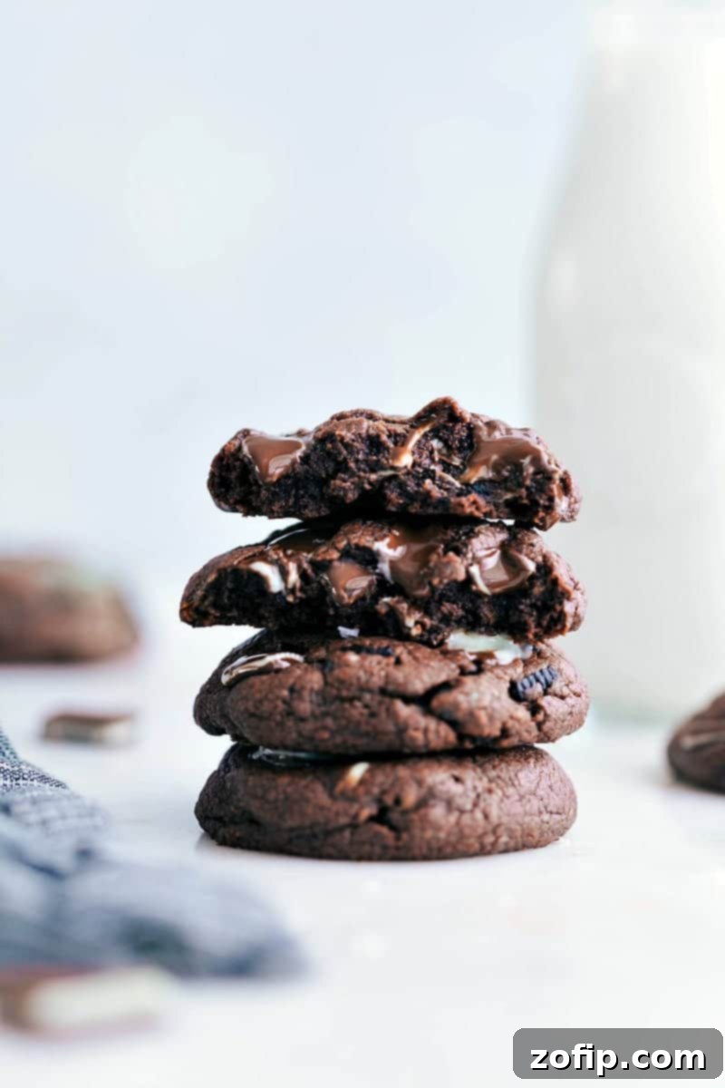 Easy and delicious Mint Chocolate Chip Cookies are bursting with flavor and so simple to make! Delicious Mint Chocolate Chip Cookies stacked on a cooling rack
