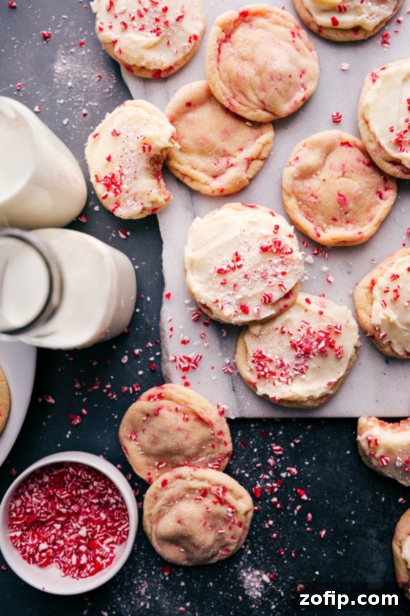 Festive Peppermint Sugar Cookies 5 The delicious holiday treat, peppermint sugar cookies, elegantly served with creamy frosting and a generous sprinkle of crushed candy canes.