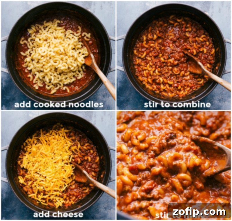 A large skillet filled with the finished American Goulash, showing tender elbow macaroni mixed with the rich beef and tomato sauce, and generously topped with melted, creamy cheese for an irresistible finish.