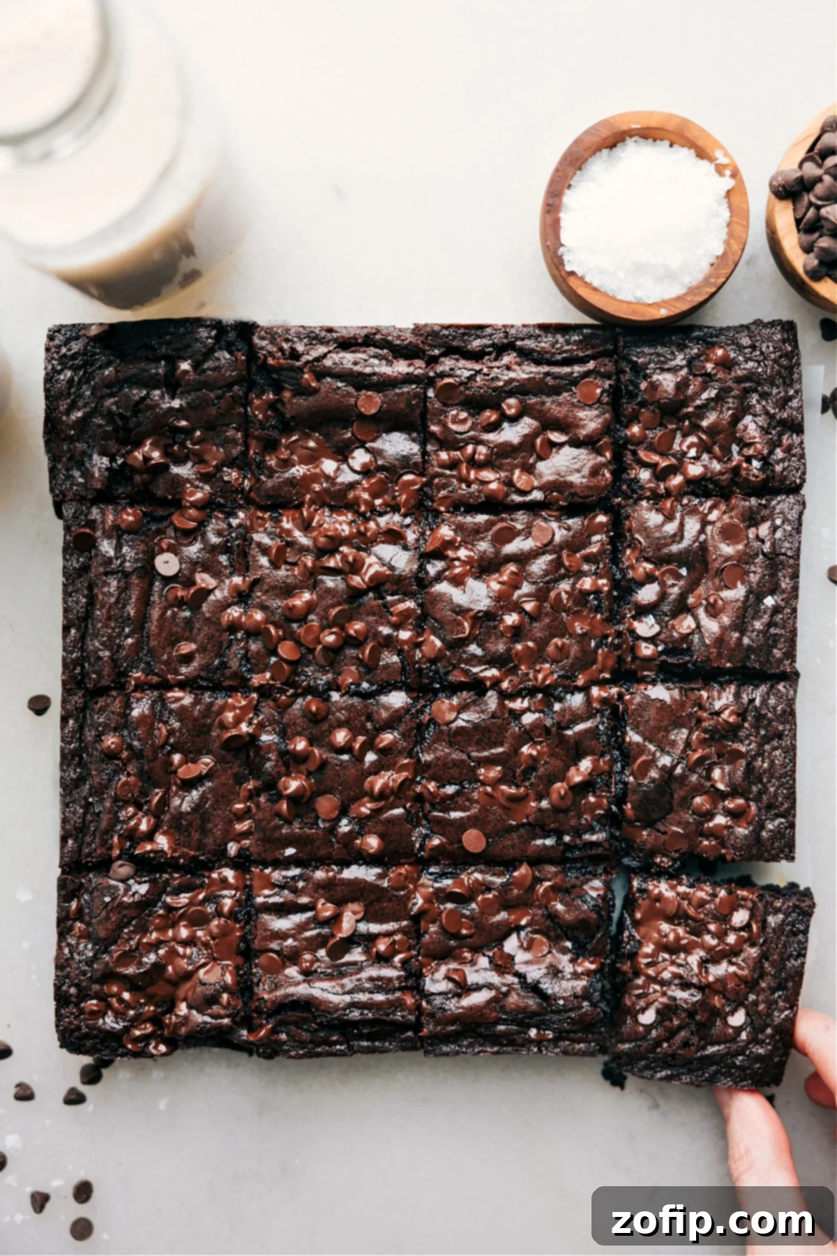 Ultra-Fudgy Brownie Recipe - The Ultimate Indulgence Fudgy Brownie Recipe: Perfectly cut squares showcasing a rich, dark interior and a crinkly top, adorned with mini chocolate chips.