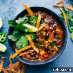Wholesome Chicken Tortilla Soup 7 A vibrant bowl of Healthy Chicken Tortilla Soup topped with fresh cilantro, avocado, and lime wedges.