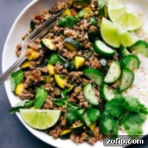 Beef Larb Recipe Image Beef larb accompanied by rice, with lime and cilantro garnishes.