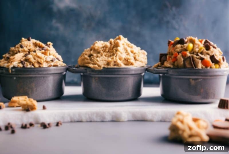 Three bowls of edible cookie dough in different flavors: classic chocolate chip, s'mores, and peanut butter cup.