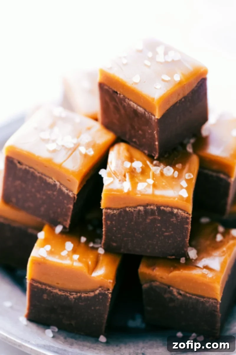 Stacks of perfectly cut Microwave Fudge pieces, showcasing the smooth chocolate and shiny caramel layers, ready for enjoyment.