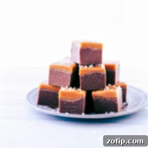 Microwave Fudge cut into cubes and stacked on a plate.