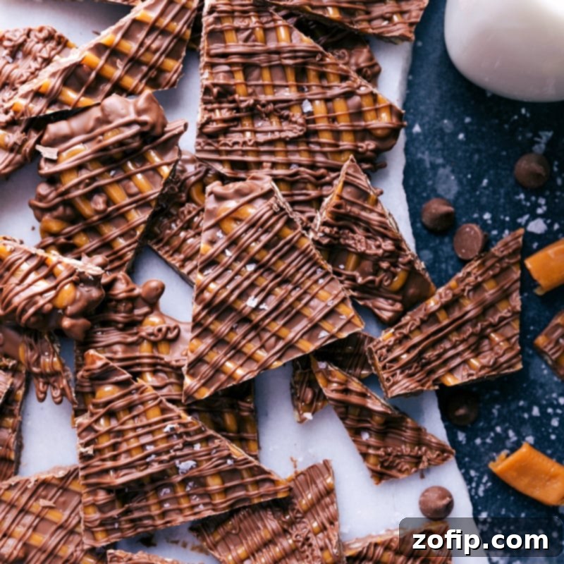 A beautifully arranged stack of cut Turtle Bark pieces, showcasing the multi-layered texture of chocolate, caramel, and pecans.