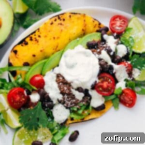 A delicious Shredded Beef Taco ready to eat, topped with fresh ingredients.