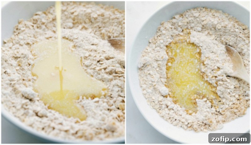Combining Wet and Dry Ingredients for Delicious Cookie Dough Melted butter being gently poured into a bowl containing a mixture of dry cookie ingredients: flour, oats, brown sugar, baking soda, and salt.