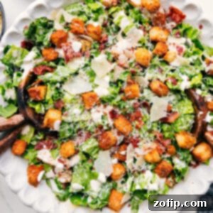 A beautifully presented Caesar Salad with dressing, croutons, and Parmesan.