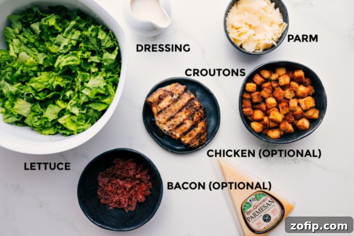 All the essential Caesar Salad ingredients neatly arranged: fresh romaine lettuce, a bowl of creamy dressing, a block of Parmesan cheese, golden homemade croutons, and optional toppings like crispy bacon and grilled chicken.